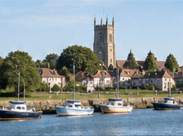 St Mary's church tower and sailing barges on the waterfront at Burnham on Crouch